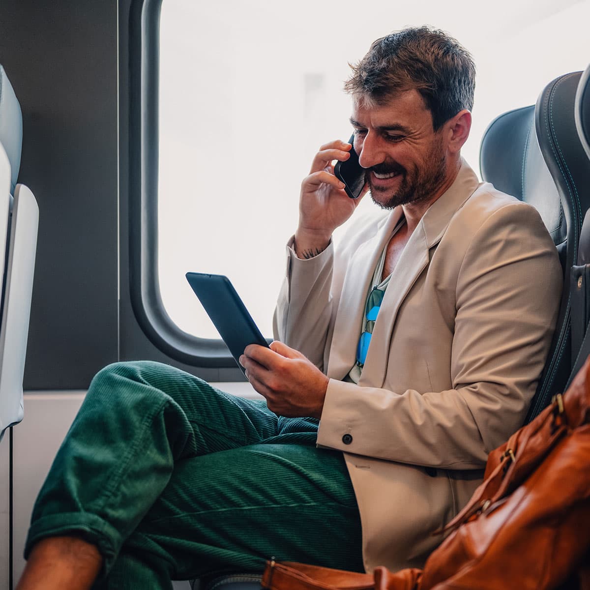 Business traveller taking a phone call on a train